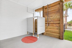 A room with a white cabinet, a wooden door, and a red rug. - Luxe 6BR Heated Pool | 200 Ft to Beach | Sleeps 20 (gulf shores)