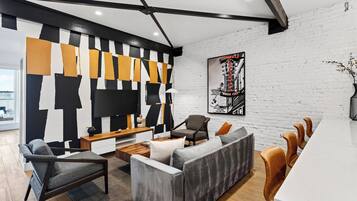 A modern living room with a sectional sofa, a coffee table, and a TV.