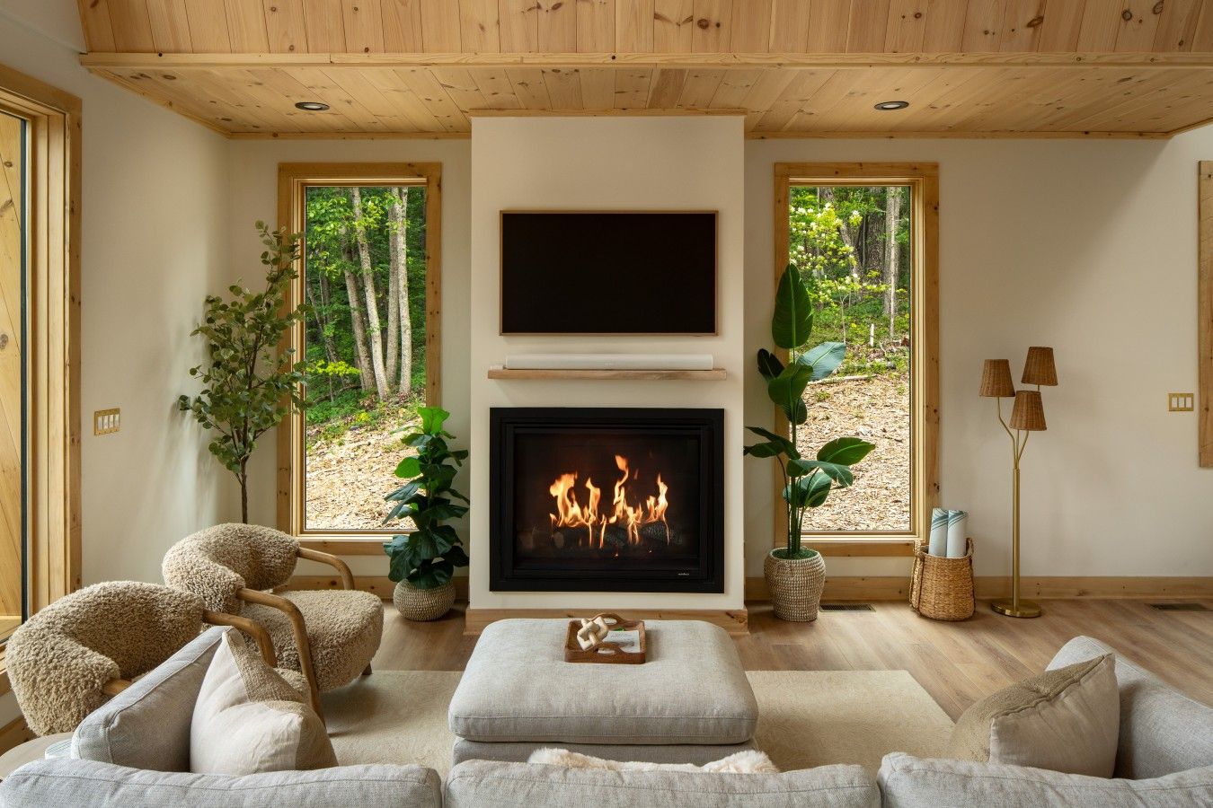 Cozy up by the fireplace after a day exploring Shenandoah, with peaceful forest views just beyond the windows