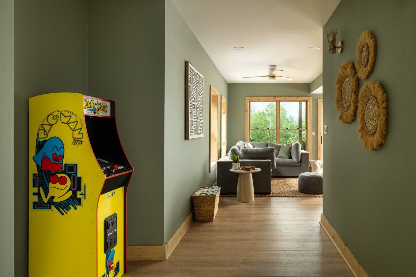 A playful lower-level game lounge brings everyone together with classic arcade fun and plenty of room to unwind.