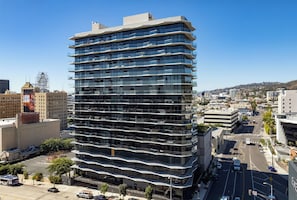 A multi-story building with a modern architectural design, featuring balconies on each floor. - Landing | Stunning 1BD in Hollywood (Los Angeles)
