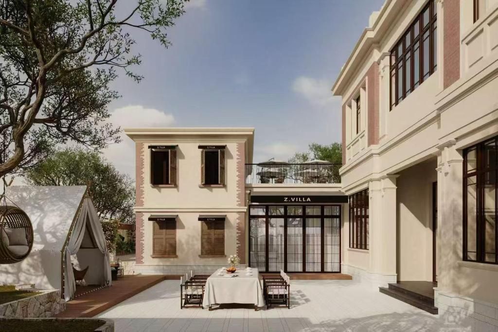 Un edificio con un restaurante llamado 'Z.VILLA' en la planta baja, un área de patio con una mesa y sillas, y una silla colgante.