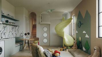 A modern kitchen with a marble backsplash, a dining area with a table and chairs, a play area with toys and a slide, and a large window providing natural light.