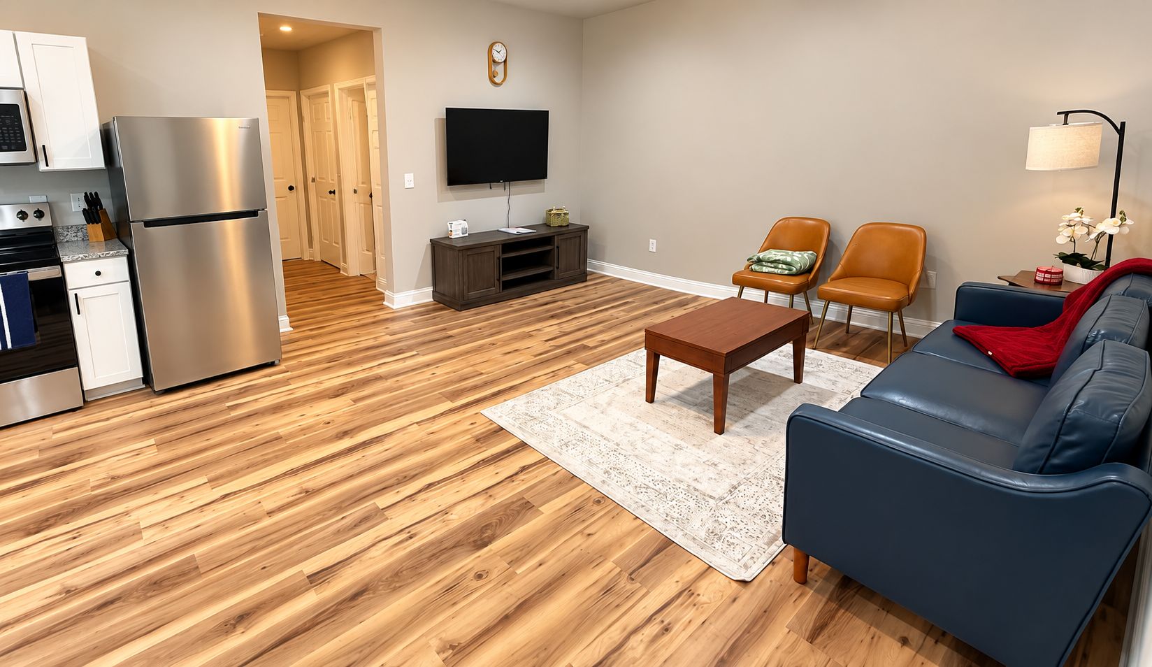 A modern apartment with a kitchen, living room, and dining area.