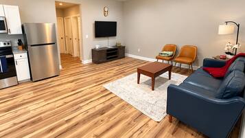 A modern apartment with a kitchen, living room, and dining area.