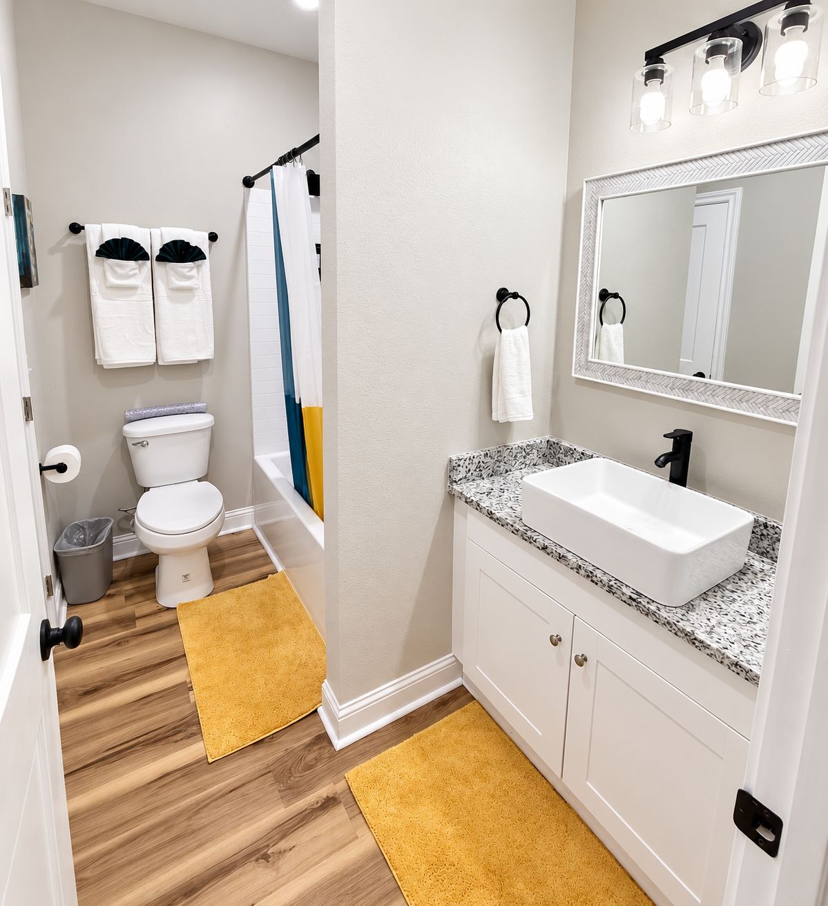 Ein Badezimmer mit Toilette, Waschbecken, Spiegel und Handtüchern.