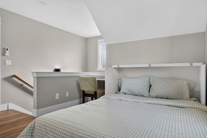 A bedroom with a bed, a desk, and a chair. - Boise 1BR w/ Patio Near BSU, Downtown & Airport (Boise)