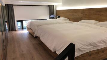 A hotel room with a large bed, wooden headboard, and a view of the outdoors.