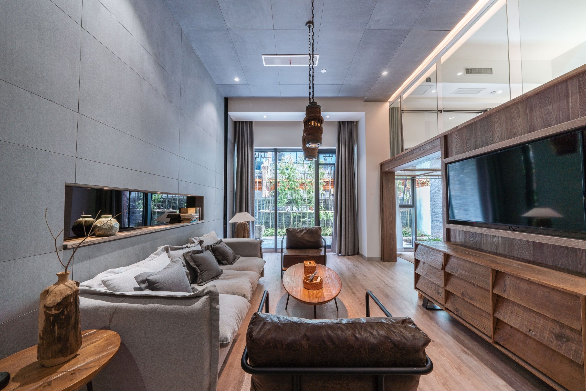 A modern living room with a sofa, a coffee table, and a television.