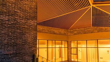 A modern building with a brick facade and a glass atrium.