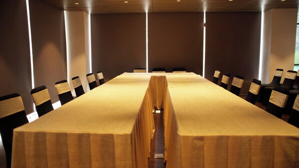 A conference room with a long table, chairs, and a modern design.