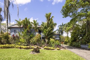 A two-story house with a garden in front. - Peaceful 2-Bedroom in Innisfail Cassowary Coast (Belvedere)