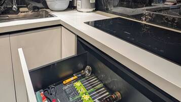 A modern kitchen with a built-in dishwasher, a microwave, and a stainless steel sink.