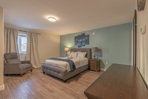 A bedroom with a bed, two bedside tables, a chair, and a wooden dresser. - Spacious , luxurious home for comfort, privacy and convenience. Great for Aurora (Yellowknife)