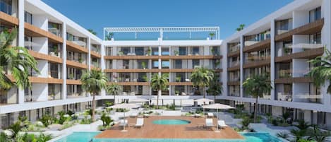 A multi-story hotel with a central pool, outdoor seating, and palm trees.
