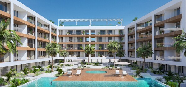 A multi-story hotel with a central pool, outdoor seating, and palm trees.