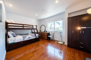 A compact room with a bunk bed, a desk, a chair, a fan, and a wardrobe. - 22ppl 7b5b Perfect family&biz stay Garage Gated (Monterey Park)