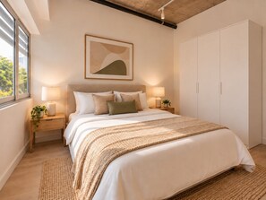 A bedroom with a bed, bedside tables, a nightstand, a large window, a wardrobe, and a painting on the wall. - City Centre 2-Bed 2-Bath Apartment Darwin (Darwin City)