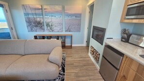 A modern kitchen with a built-in microwave, a toaster, and a knife block.