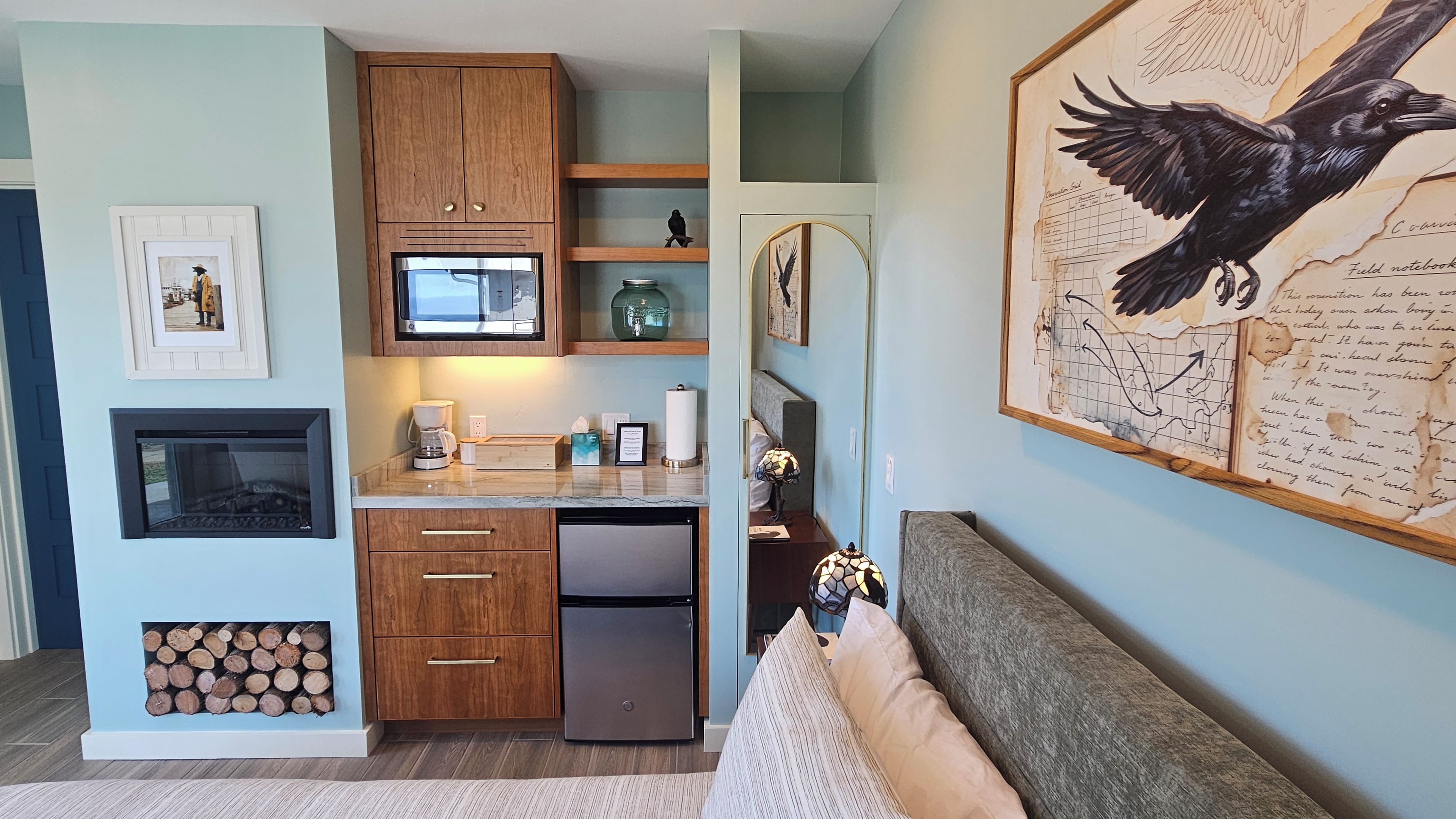 A modern kitchen with wooden cabinets, a built-in microwave, and a coffee maker.