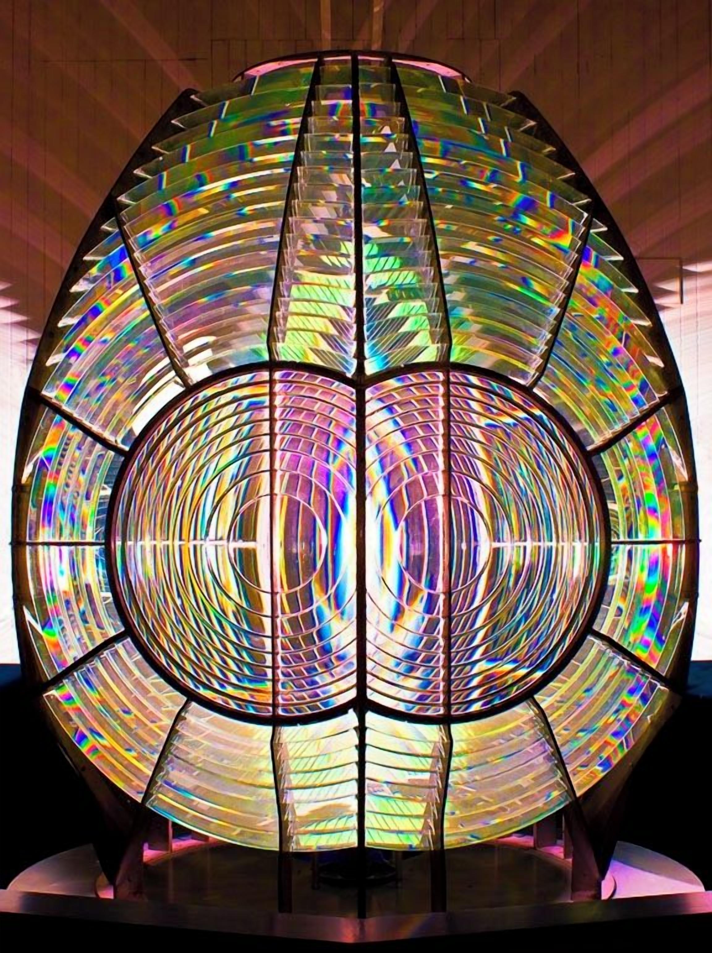 A spherical stained glass structure with radial lines and a reflective surface.