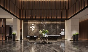 A modern lobby with a reception desk, a chandelier, and a large mirror. - Intercity Hotel Shanghai Xinzhuang Biz (Shanghai)
