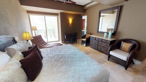 A hotel room with a bed, a desk, a chair, a dresser, and a large mirror. - Molino De Agua 209 Located in Old Town on Los Muertos Beach 3BD Condo for rent i (Puerto Vallarta)