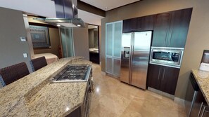 A modern kitchen with granite countertops, stainless steel appliances, and a built-in oven. - Molino De Agua 209 Located in Old Town on Los Muertos Beach 3BD Condo for rent i (Puerto Vallarta)