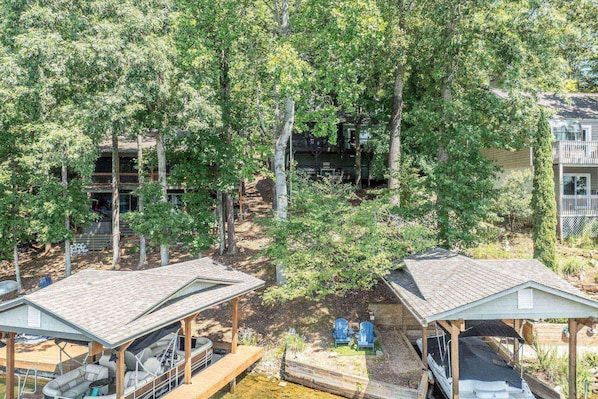 A cabin with a covered deck and a boat dock.