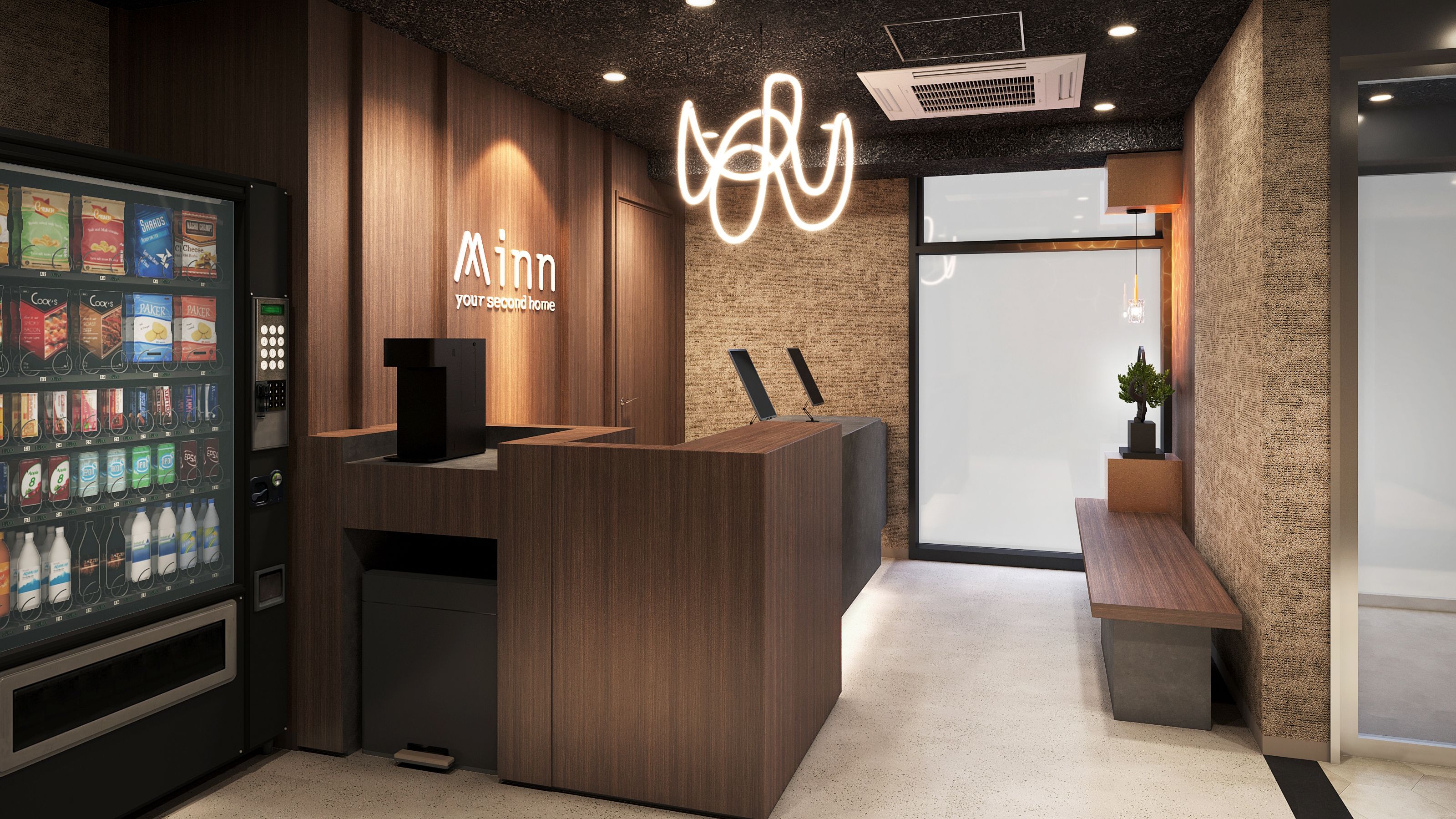 A reception area with a wooden reception desk, a beverage vending machine, and a wall-mounted light fixture.