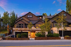 An impressive mountain home with a warm exterior and beautiful evening light. - Hot Tub + Cedar Sauna + Game Room | Walk to Main St | Alpine Ridge Lodge (Park City)
