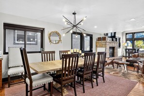 Gather around the dining table beneath a statement chandelier for memorable meals at home. - Hot Tub + Cedar Sauna + Game Room | Walk to Main St | Alpine Ridge Lodge (Park City)