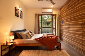 A bedroom with a bed, bedside table, lamp, and a view through a window. - LiveAway Bengaluru (HSR) by PACK (Bengaluru)