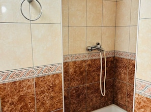 A bathroom with a shower area, tiled walls, and a decorative border. - Apartments Adriana - Two Bedroom Apartment 10 (Gradac)