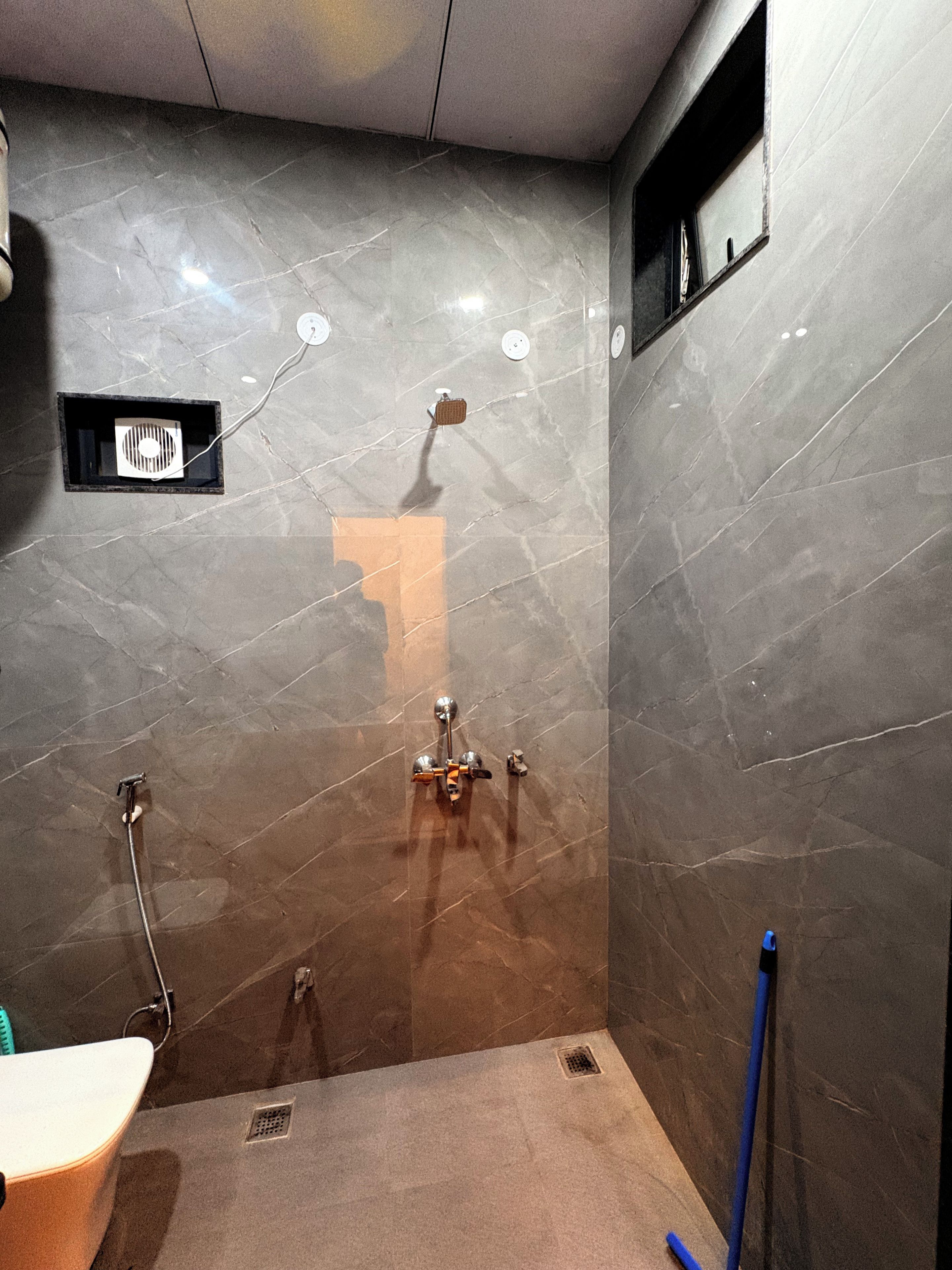 A bathroom with a shower, a sink, and a mirror.