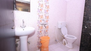 A bathroom with a white sink, toilet, and a decorative floral wall. - Hotel NoVo Agra (Agra)