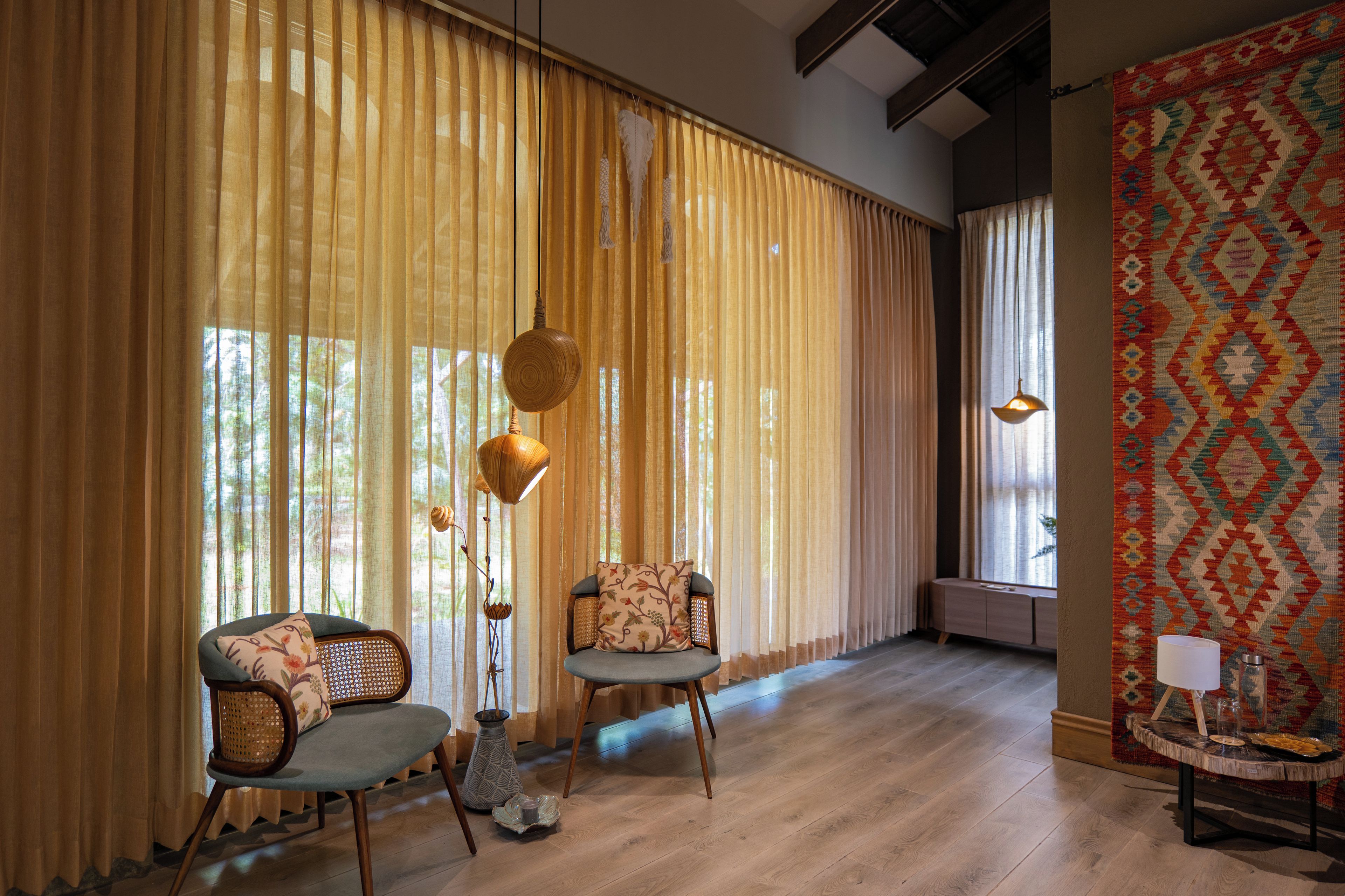 A room with two chairs, a small table, and a patterned rug.