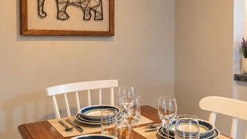 Cozy dining nook with seating for four and stylish modern wall art