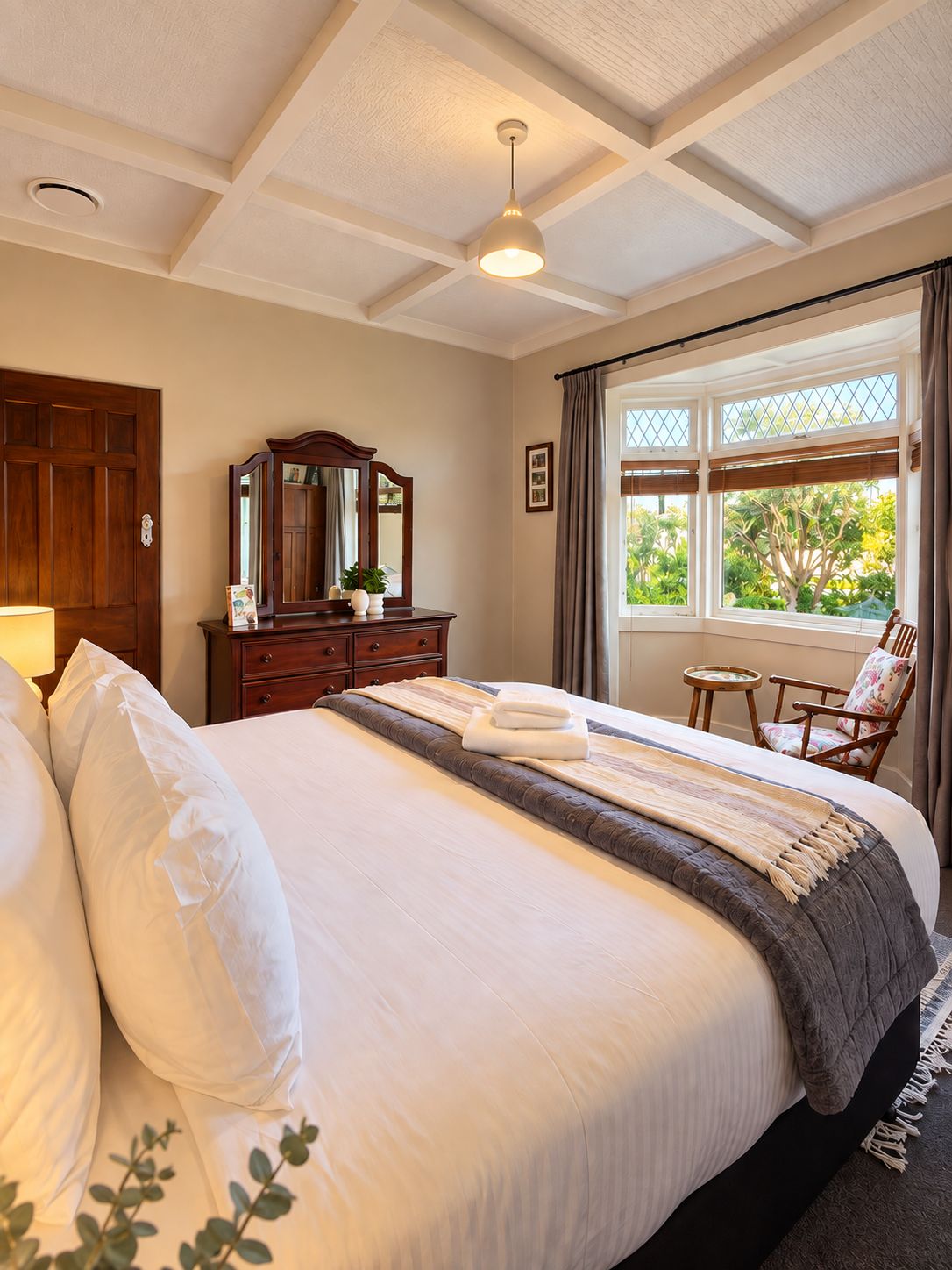 Bright, elegant bedroom with garden views and timeless charm
