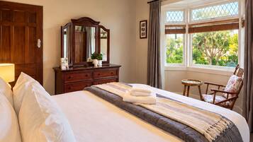 Bright, elegant bedroom with garden views and timeless charm