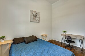 A bedroom with a bed, a desk, a chair, and a small table. - Home Theater & Game Room! 7BR San Antonio Retreat (San Antonio)
