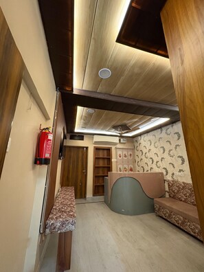 Una habitación con techo de madera, un extintor, una recepción y una pared con diseño.