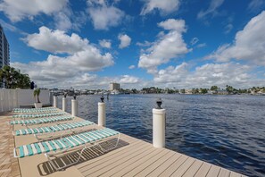 A waterfront deck with lounge chairs and a view of the water and city skyline. - 1 Block to Sand! Ocean-View Retreat w/ Pool Access (Fort Lauderdale)