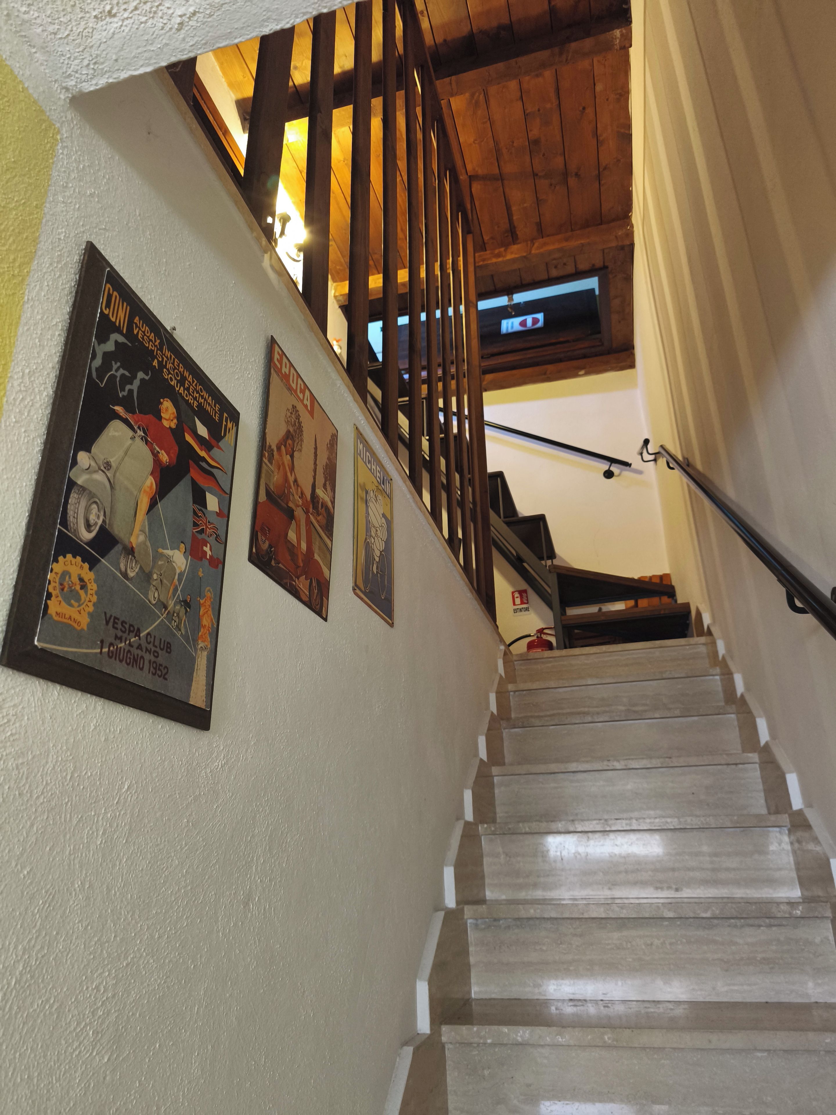 Eine Treppe mit Holzhandläufen und einer Geländer, die zu einer oberen Etage führt.