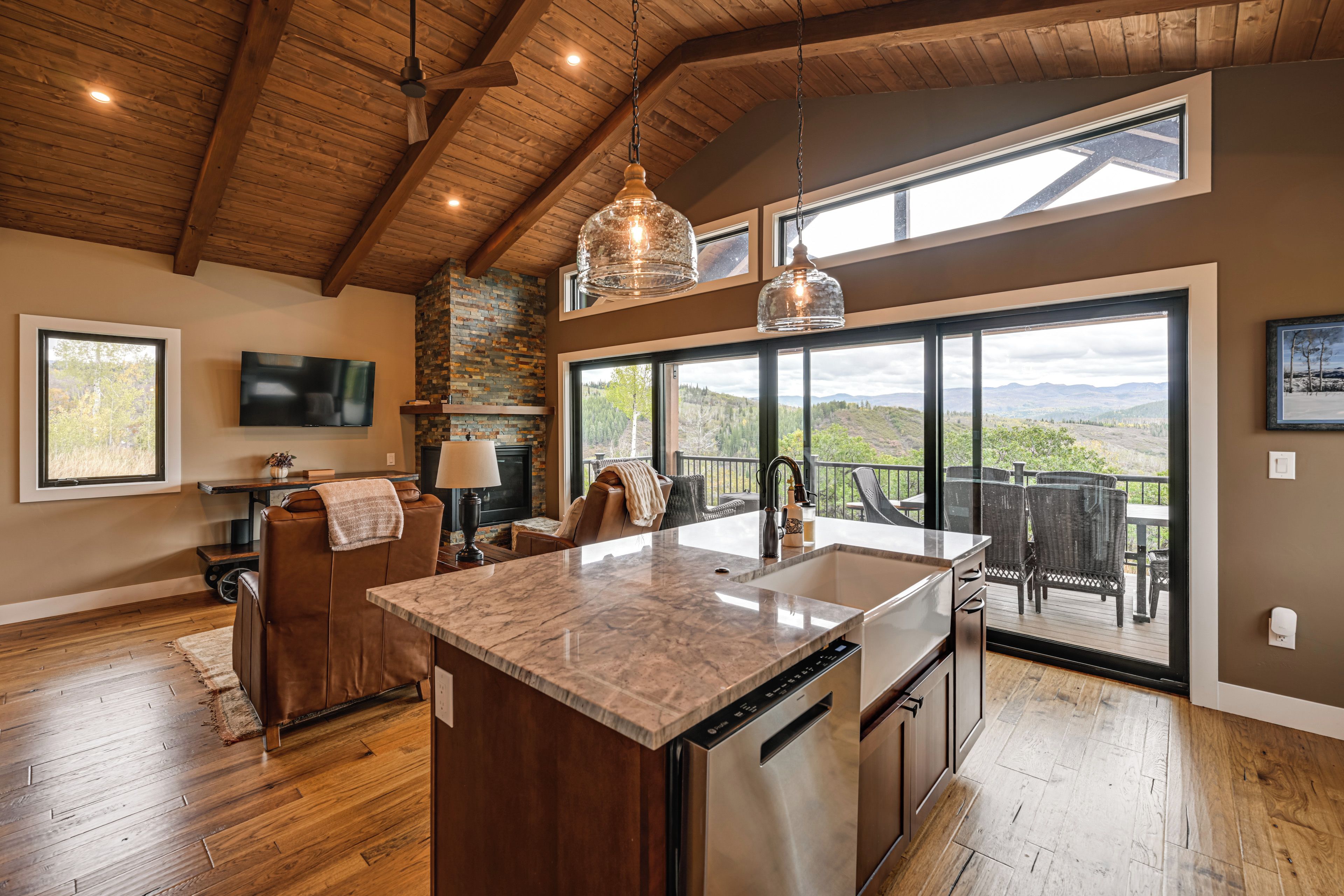 A spacious kitchen with a large island, a dining area with a view, and a cozy seating area.