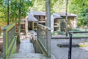 A wooden staircase leading to a building with multiple balconies, surrounded by trees. - Hilltop Hideaway in Sapphire Near Lake Glenville (Sapphire)