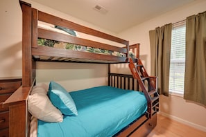 A bunk bed with a wooden frame, a blue mattress, and a ladder. - Family Home < 1 Mi to Lake & Paris Landing! (Buchanan)
