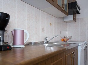 A kitchen with a coffee maker, a glass bowl, and a sink. - Apartments Marko - Three Bedroom Apartment With Sea View (Novi Vinodolski)