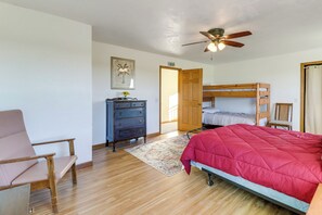 A bedroom with a bunk bed, a desk, a chair, a ceiling fan, and a door. - 'WillowField' Fire Pits, Game Room & Group Fun (Roosevelt)