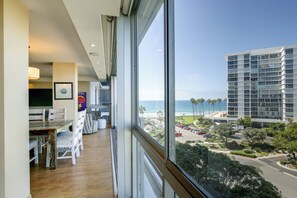 A hotel room with a large window offering a view of the beach and ocean. - Beach + Poolside Days! Extended Coronado Escape (Coronado)